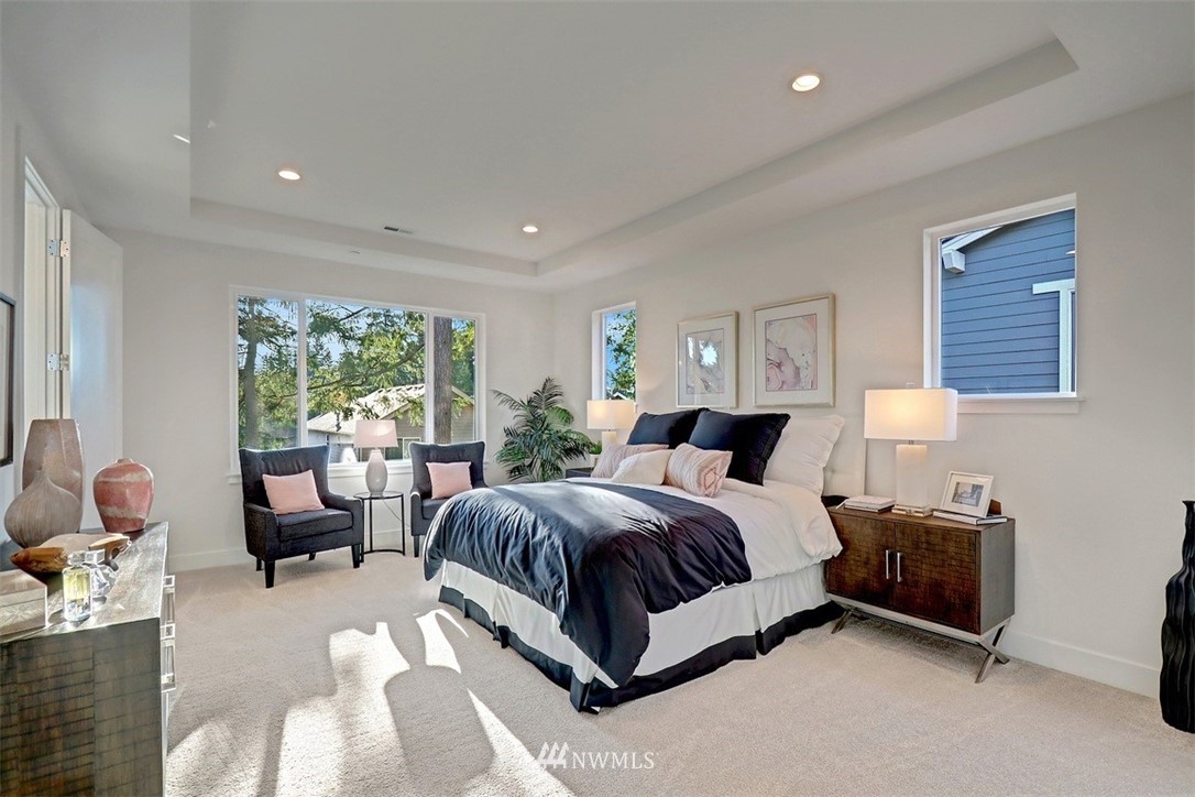 102 232nd Place Southeast, Unit 13 Bothell, WA 98021 - Photo 14 of 26 a spacious bedroom with a bed and a couch