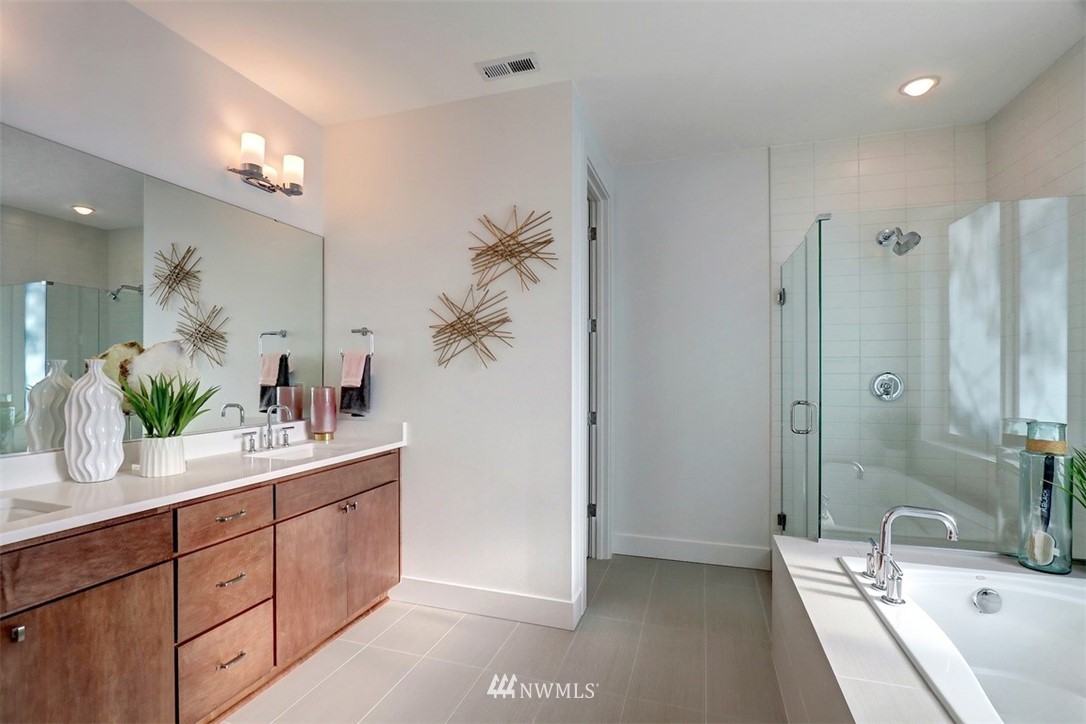 102 232nd Place Southeast, Unit 13 Bothell, WA 98021 - Photo 15 of 26 a bathroom with a double vanity sink a mirror and a shower