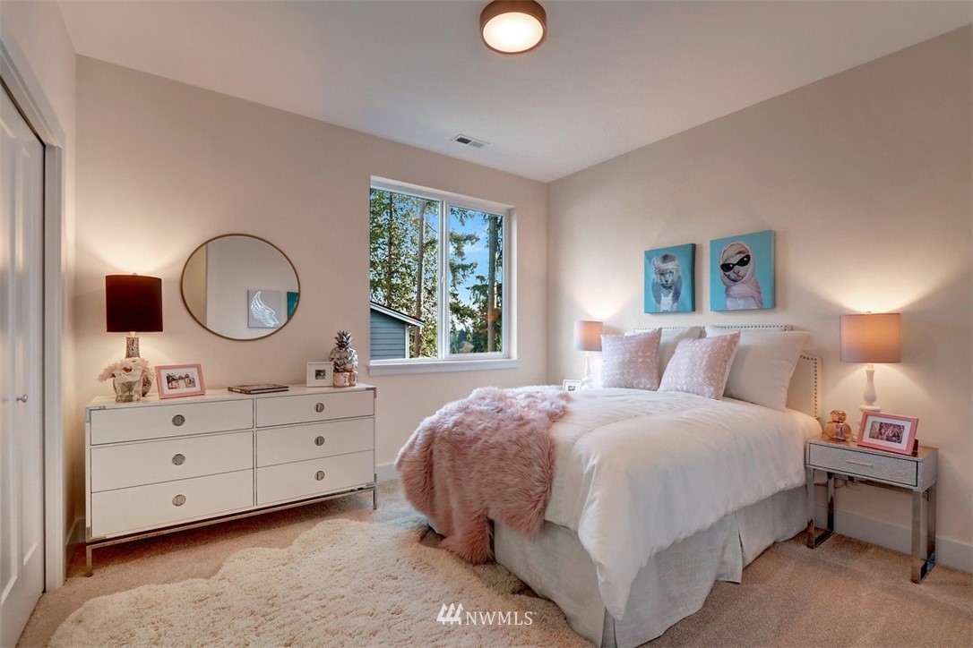 102 232nd Place Southeast, Unit 13 Bothell, WA 98021 - Photo 17 of 26 a bedroom with a bed and a dresser