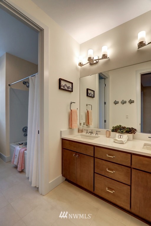 102 232nd Place Southeast, Unit 13 Bothell, WA 98021 - Photo 20 of 26 a bathroom with a double vanity sink and a mirror