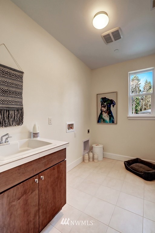 102 232nd Place Southeast, Unit 13 Bothell, WA 98021 - Photo 21 of 26 a spacious bathroom with a sink mirror and toilet