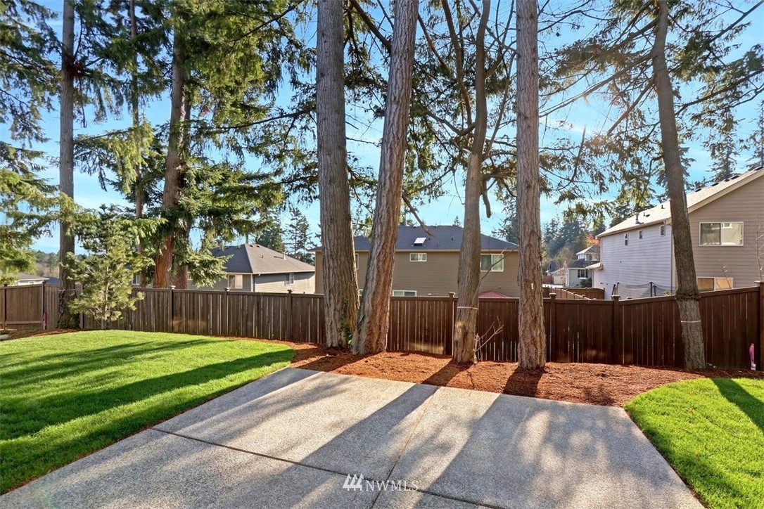 102 232nd Place Southeast, Unit 13 Bothell, WA 98021 - Photo 23 of 26 a front view of a house with a yard