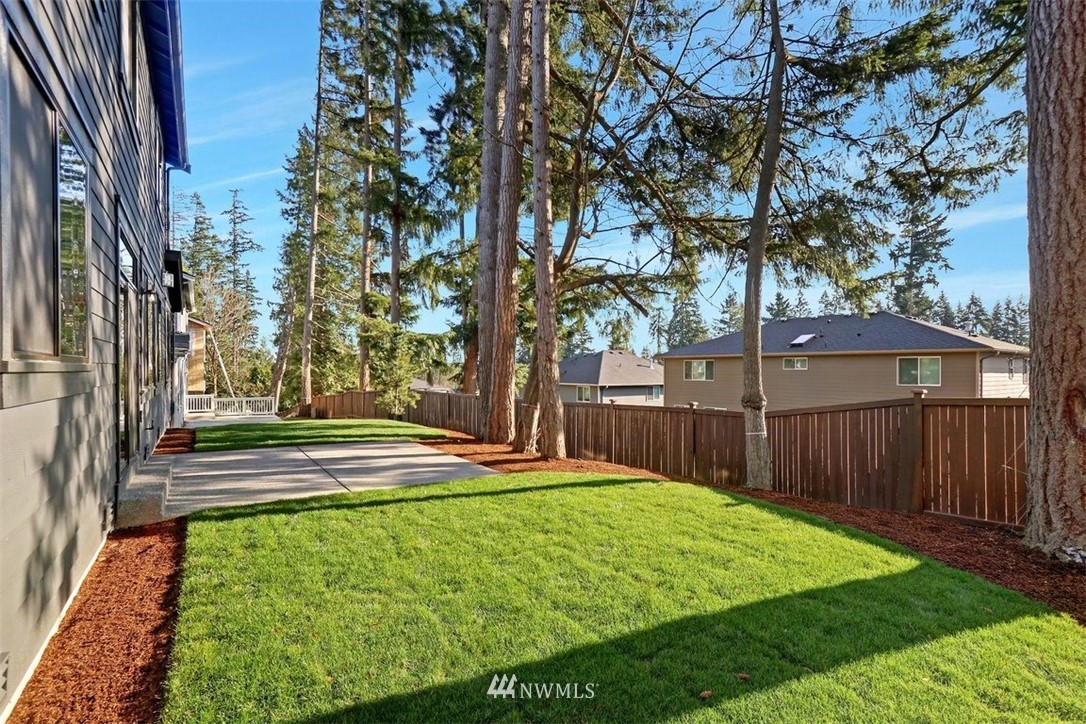 102 232nd Place Southeast, Unit 13 Bothell, WA 98021 - Photo 25 of 26 a view of a yard with large trees