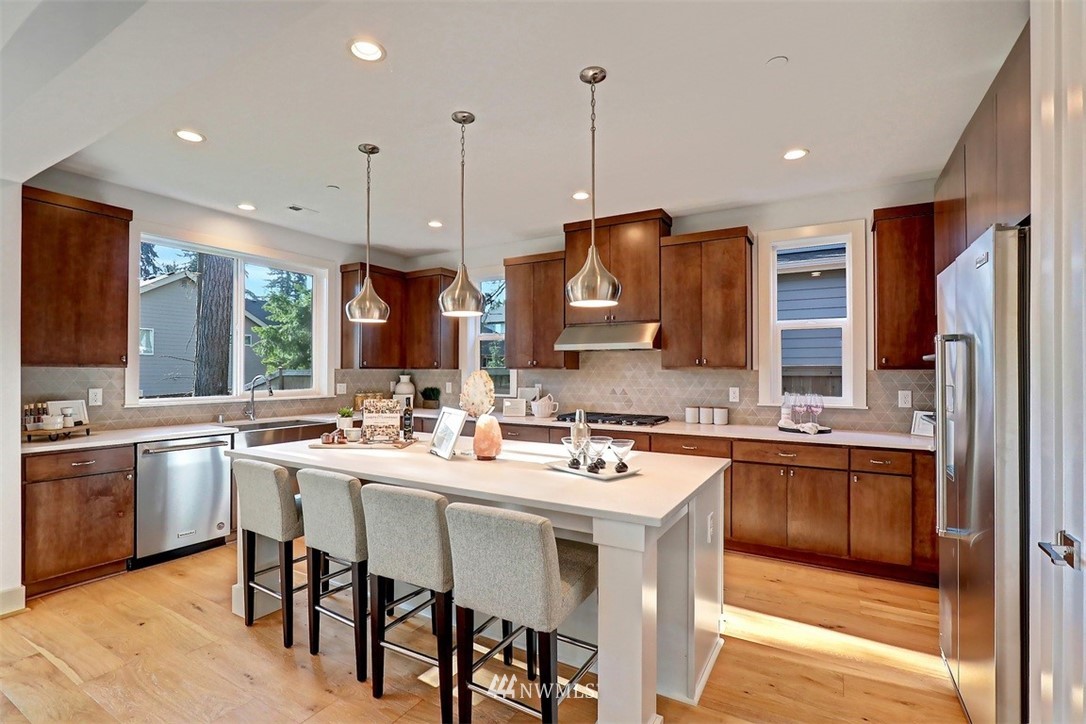 102 232nd Place Southeast, Unit 13 Bothell, WA 98021 - Photo 5 of 26 a kitchen with lots of counter space a sink appliances and living room view