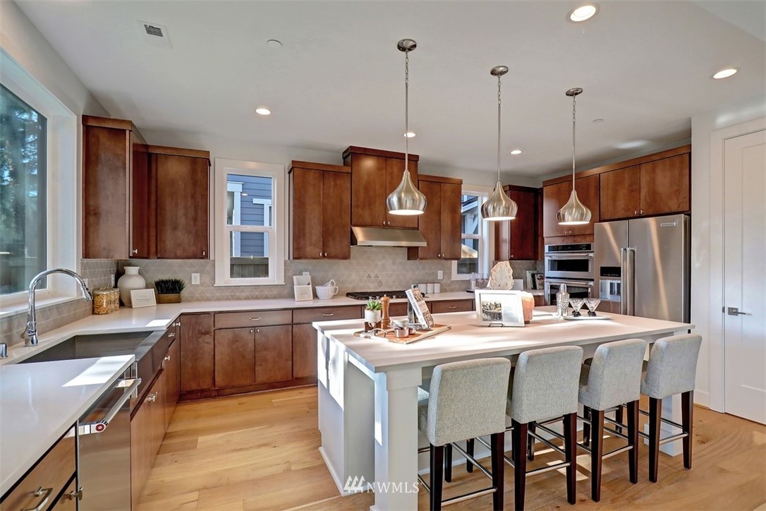 102 232nd Place Southeast, Unit 13 Bothell, WA 98021 - Photo 6 of 26 a large kitchen with a table and chairs