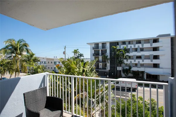 a view of a balcony with wooden floor and fence