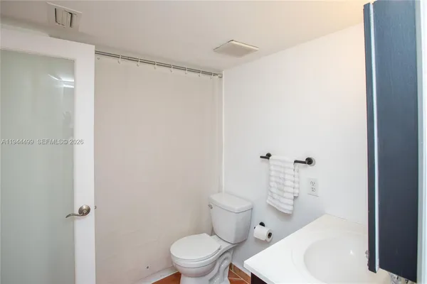 a bathroom with a sink toilet vanity and tub