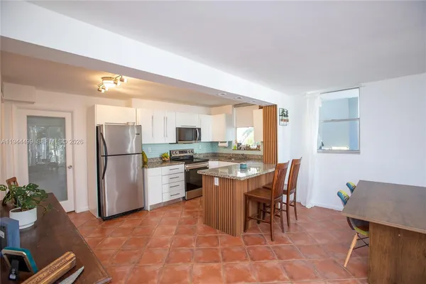 a kitchen with a refrigerator a stove and a sink