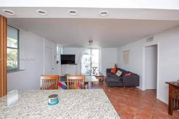a kitchen view with living room stove and window
