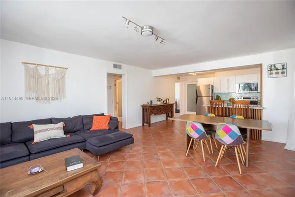 a living room with furniture and dining area