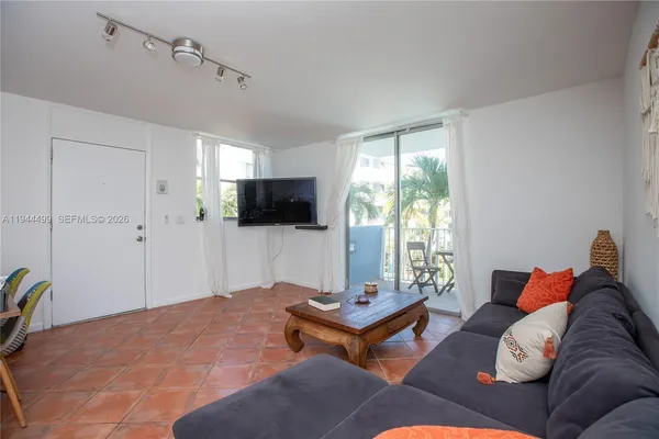 a bedroom with furniture and a flat screen tv