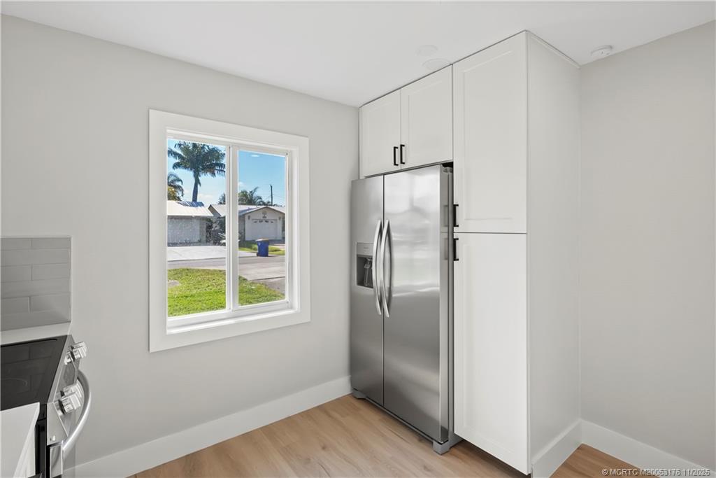 3023 Southeast Banyan Street Stuart, FL 34997 - Photo 11 of 24 a view of hallway with window and wooden floor