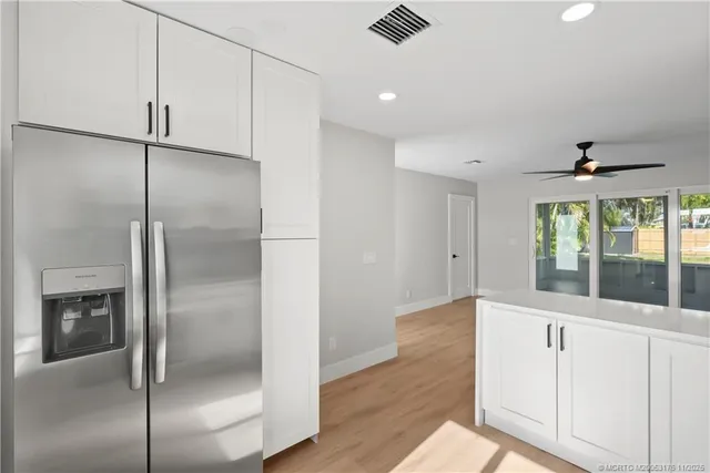 a kitchen with a refrigerator and window