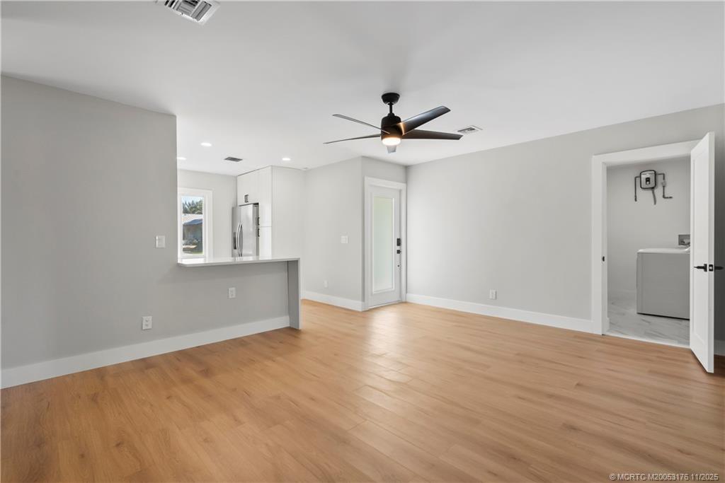 3023 Southeast Banyan Street Stuart, FL 34997 - Photo 13 of 24 a view of an empty room with window and wooden floor