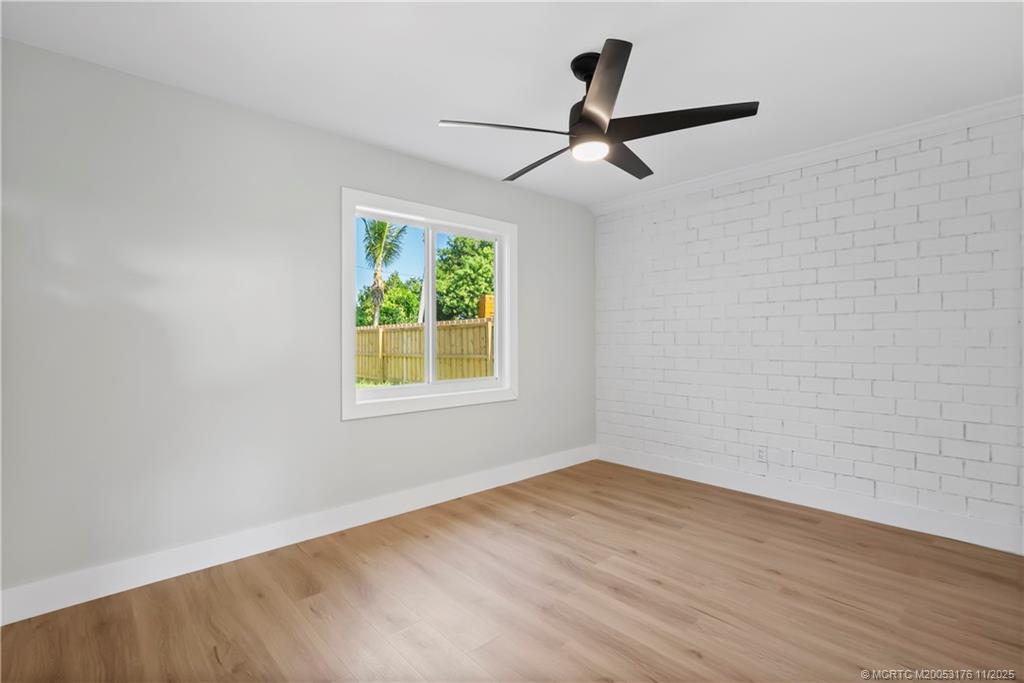 3023 Southeast Banyan Street Stuart, FL 34997 - Photo 15 of 24 an empty room with a window and a ceiling fan