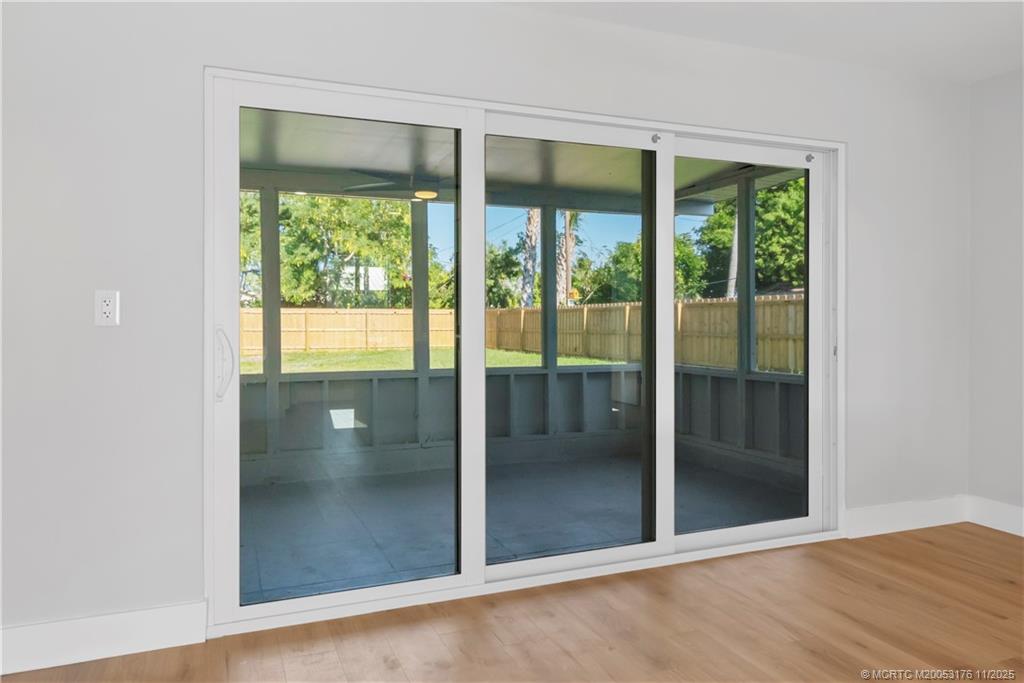 3023 Southeast Banyan Street Stuart, FL 34997 - Photo 20 of 24 an empty room with sliding glass door