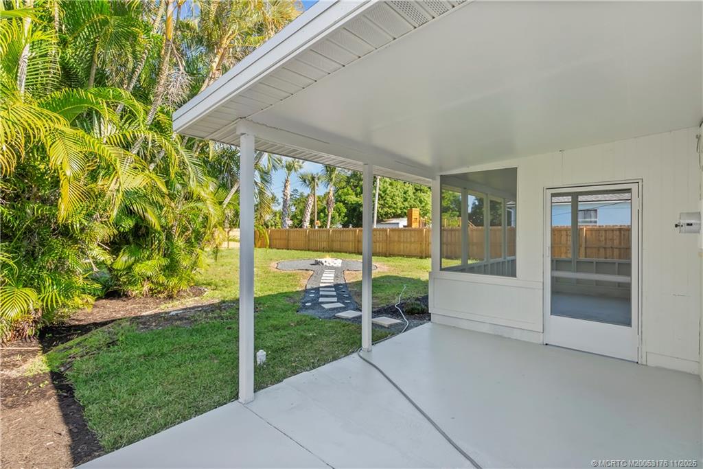 3023 Southeast Banyan Street Stuart, FL 34997 - Photo 22 of 24 a porch with a garden view