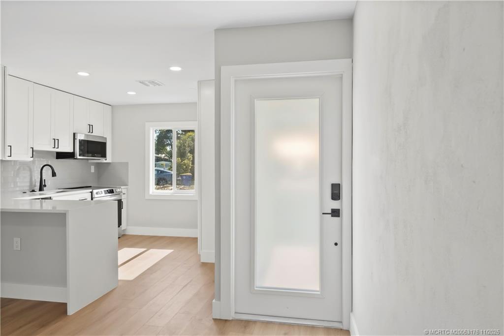3023 Southeast Banyan Street Stuart, FL 34997 - Photo 7 of 24 a living room with stainless steel appliances granite countertop furniture and a window