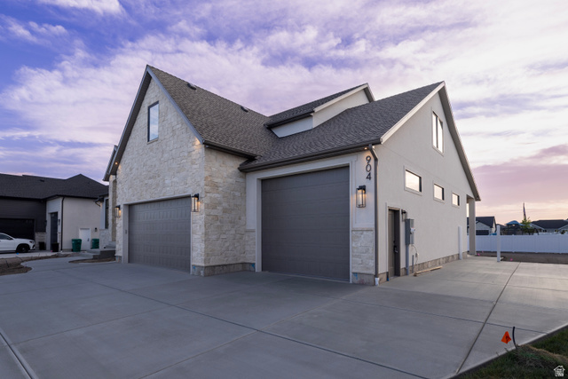 904 South 1900 West Layton, UT 84041 - Photo 2 of 19 View of side of property featuring stone siding and driveway