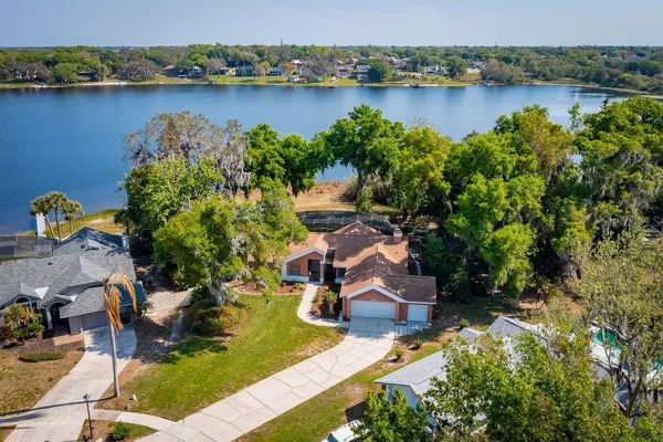 an aerial view of lake residential house with outdoor space and seating