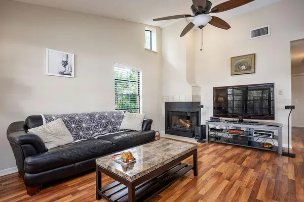 a living room with furniture a flat screen tv and a fireplace