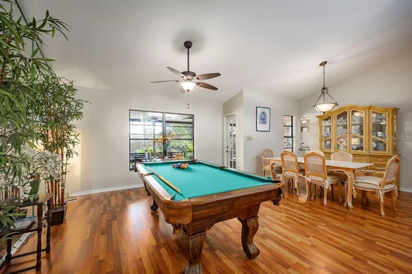 a view of a dining room with furniture and wooden floor
