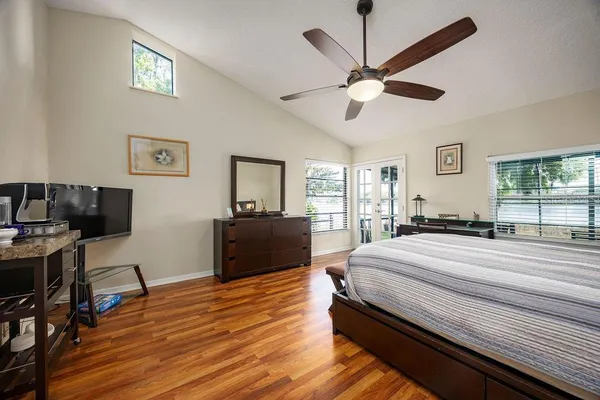 a bedroom with a bed and wooden floor