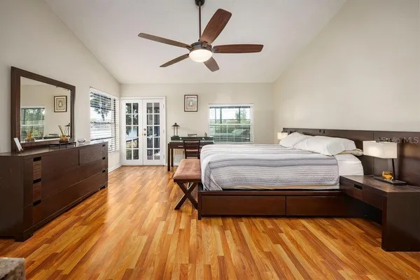 a bedroom with a bed and wooden floor