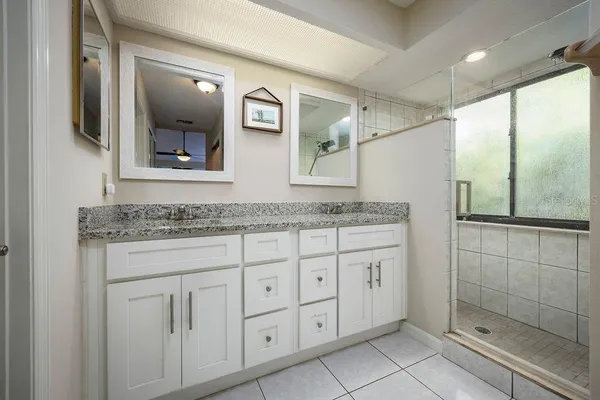 a bathroom with a granite countertop sink mirror and