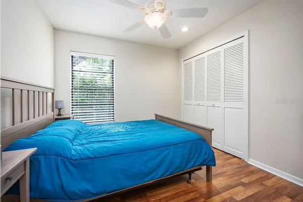 a bed sitting in a bedroom next to a window