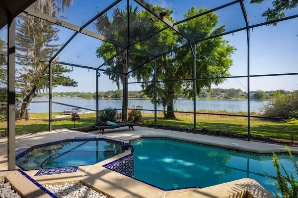 a view of swimming pool with a lounge chairs