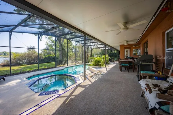 a swimming pool with outdoor seating and yard
