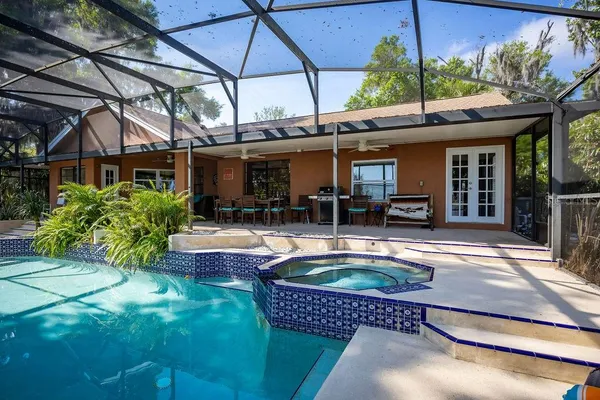 a swimming pool with patio outdoor seating and yard