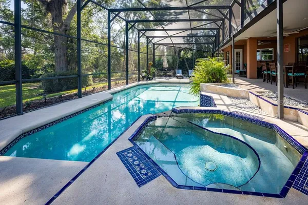 a swimming pool with outdoor seating and yard