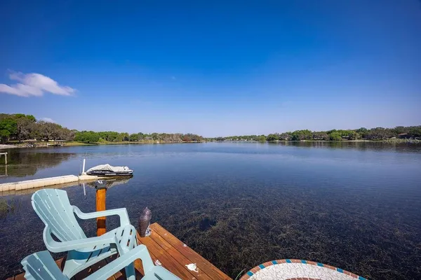 a view of a lake with furniture