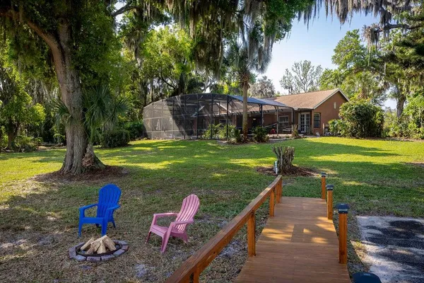 a view of a swimming pool with a yard and plants