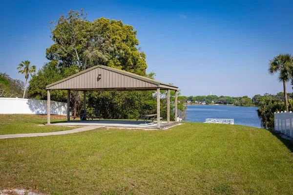 a view of a house with a yard table and chairs under an umbrella