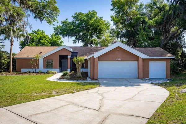 a front view of a house with a yard and garage