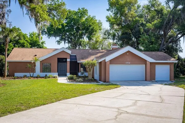 a front view of house with yard and green space