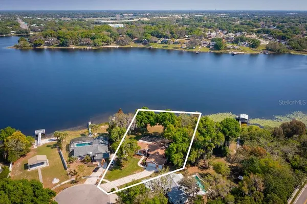 an aerial view of a residential houses with outdoor space and swimming pool