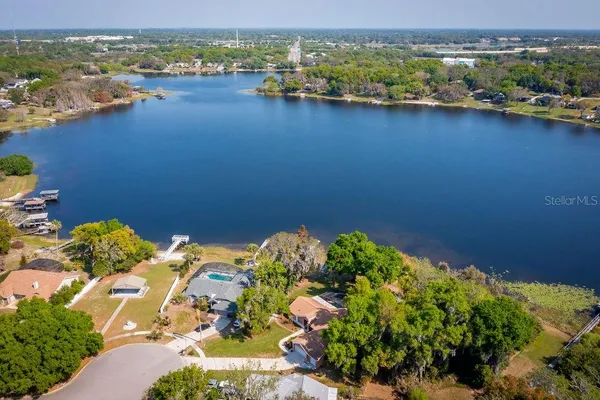 an aerial view of a houses with a lake view
