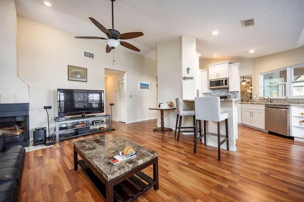a living room with dining room and wooden floor