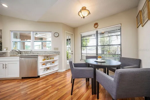 a view of a dining room with furniture and windows