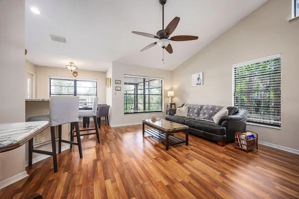 a living room with furniture and a wooden floor
