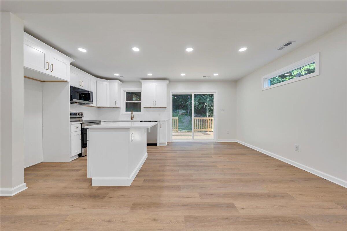 3713 Pinevale Road Roanoke, VA 24018 - Photo 14 of 46 a view of kitchen with granite countertop refrigerator oven a sink and white cabinets with wooden floor