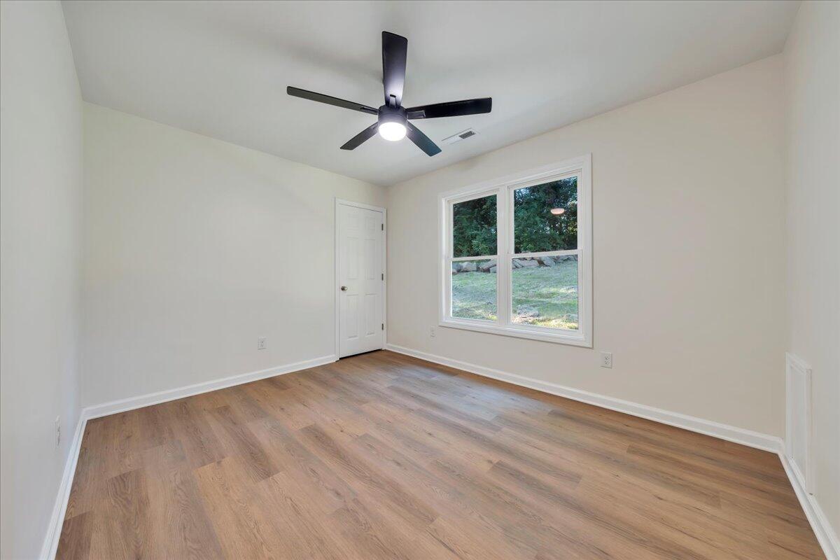 3713 Pinevale Road Roanoke, VA 24018 - Photo 21 of 46 an empty room with wooden floor ceiling fan and windows