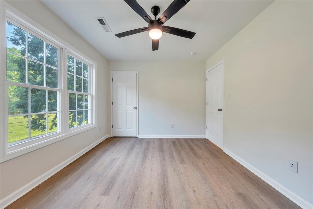 3713 Pinevale Road Roanoke, VA 24018 - Photo 24 of 46 an empty room with wooden floor and windows