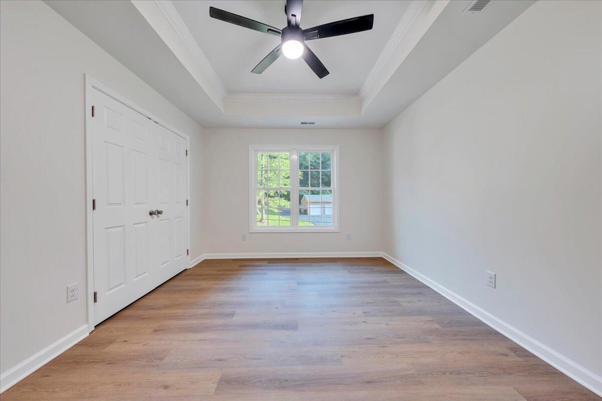 3713 Pinevale Road Roanoke, VA 24018 - Photo 25 of 46 an empty room with wooden floor chandelier fan and windows