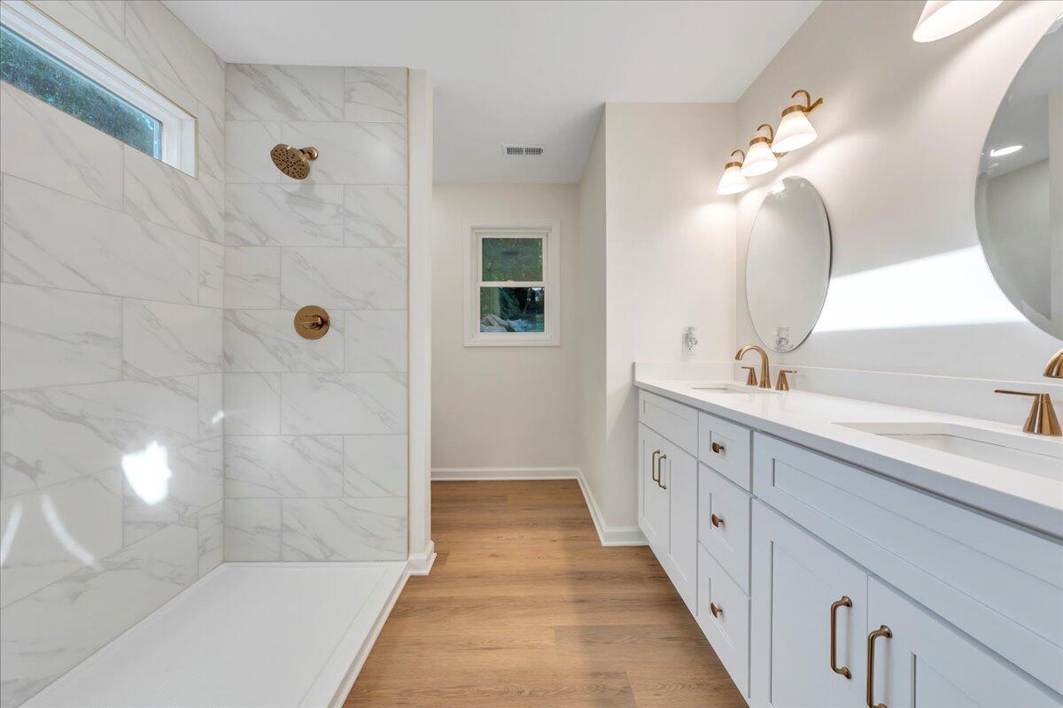 3713 Pinevale Road Roanoke, VA 24018 - Photo 31 of 46 a spacious bathroom with a double vanity sink a large mirror and shower