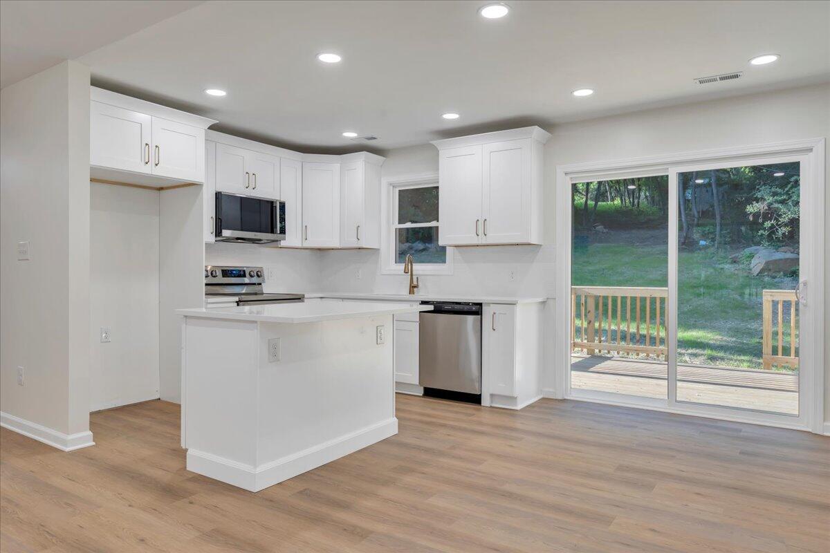 3713 Pinevale Road Roanoke, VA 24018 - Photo 6 of 46 a kitchen with kitchen island wooden floors appliances and cabinets